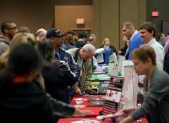 People standing around a table at a career fair